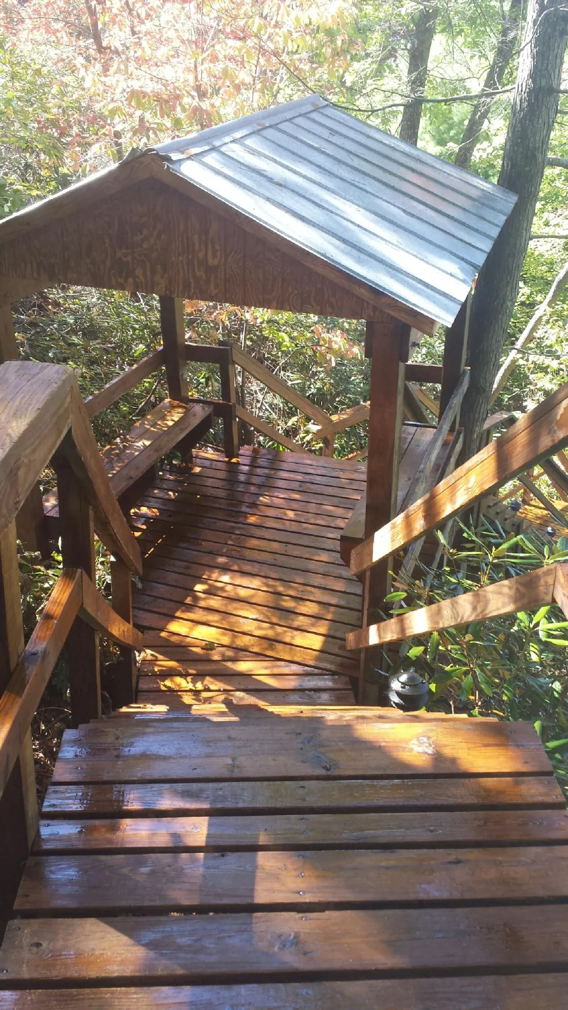 Freshly stained wood walkway and covered shelter with a metal roof in Pitcairn
